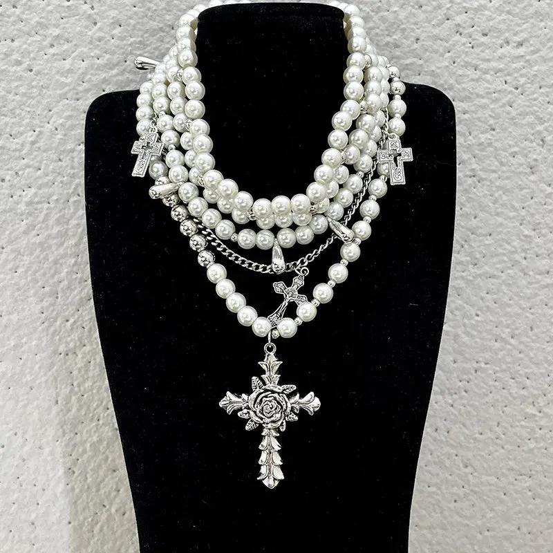 Pearl beaded necklaces are layered with men's and women's sweaters